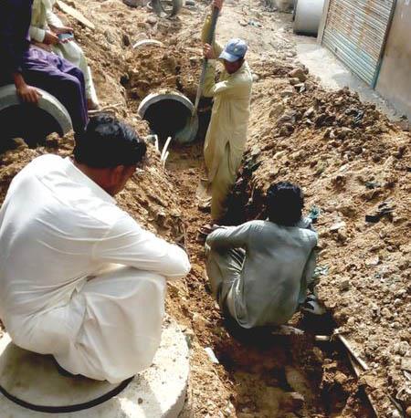 Road carpeting work along with sewerage work is being performed in Orangi Town  District West, Karachi.